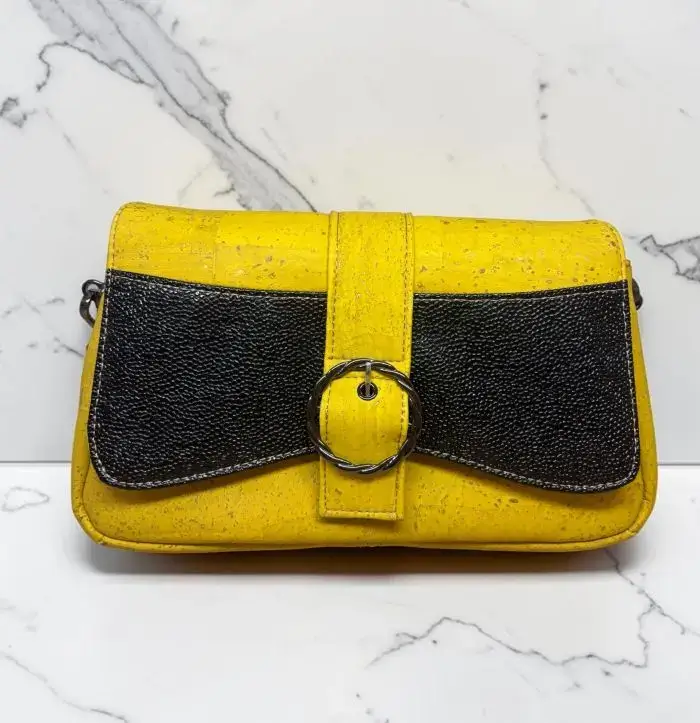 Sac à main femme en liège végétalien. Couleur jaune et empiècement noir motif grainé brillant Format pochette compacte. Porté bandoulière.