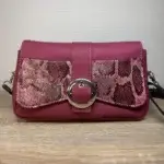 Sac à main femme en cuir écologique. Couleur vert. Format pochette compacte. Porté bandoulière. Empiècement effet peau de serpent. avant avec boucle ronde métal argenté.