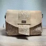 Sac à main de fabrication artisanale en liège végétal beige naturel et imprimé arabesque blanc. Modèle avec rabat et bandoulière réglable. Vue de face.