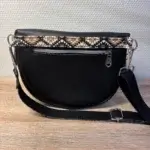 Sac banane en cuir synthétique noir effet satiné. Trois poches zippées. Intérieure toile imperméable. Bandoulière réglable. vue dos.